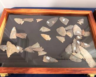 Native American arrowheads and stone spear points, display case