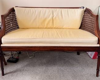 Cane Frame Settee / Bench. Significant Fading on Cushion. Cane Needs Repair. Measures 43" W x 23" D with 18" Seat Height.  Photo 1 of 5. 