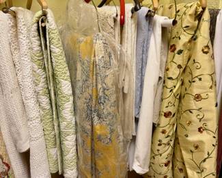Added 22-May-2026.  Racks of quilts, bedspreads and drapery.