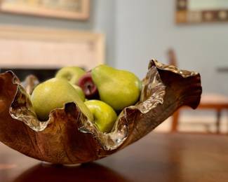 Wooden fruit in brown freeform bowl.
