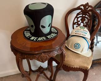Side table with chair and hats