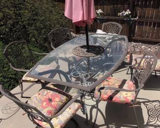 Wrought Iron Patio Dining Set with Glass Tabletop and Floral Cushions
