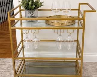 Gold and glass bar cart, contemporary entertaining decor, modern glam serving cart, rolling beverage cart, wine storage, glass shelving, contemporary home furnishings