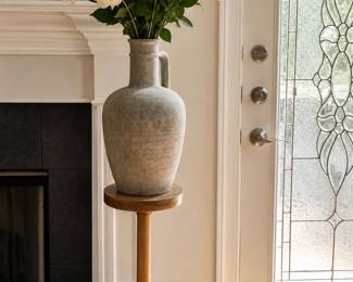 Oversized contemporary floor vase with pedestal stand available. Contemporary organic and designer-inspired decor throughout the home including vases, accent pieces, mirrors, artwork, and decorative accessories. Florals shown for styling purposes only and are not included with purchase.