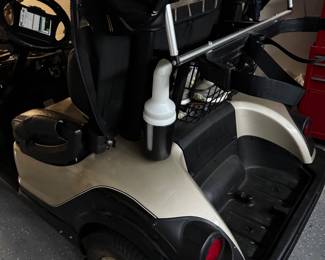 Yamaha gas-powered golf cart featuring custom two-tone seating, upgraded wheels, windshield, overhead storage, and premium canopy enclosure. Clean well-maintained condition with comfortable seating and stylish Village-ready appearance. Great for neighborhood cruising, recreation, or everyday community transportation.