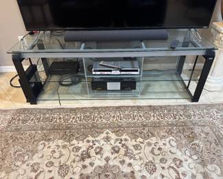 - Bell'O Glass Console Table with black curved legs.