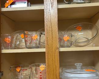 Numerous Pyrex vintage measuring cups and dishes