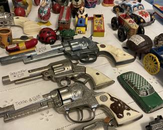 Vintage cap guns and tin toys.