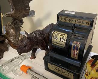 Brass eagles, carved wood rhino, Uncle Sam cash register