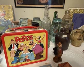 Popeye lunchbox complete with thermos. Lots of antique bottles.