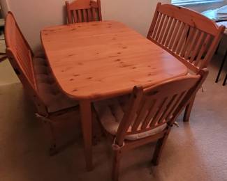 Kitchen table with two chairs and two benches