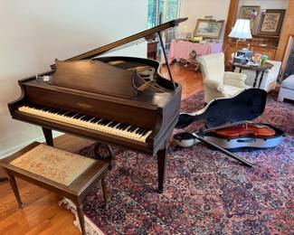 A beautiful Chickering baby grand piano and 11.3 x 16.5 Karastan rug, cleaned recently too! Full size cello