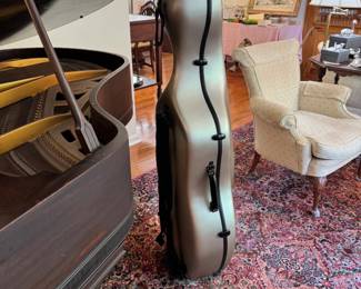 A full size cello with very nice rolling case and bow. Unlabeled. Maple with ebony fingerboard