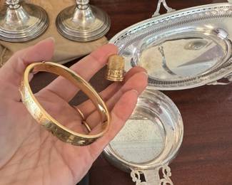 Sterling pieces in background and 14K gold bracelet and 14K size 9 thimble