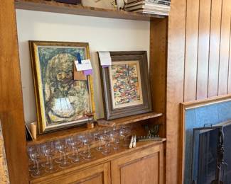 LEFT 1972 Manuel Lizama original painting, "Decadencia" with lots of paperwork; a personal note about collecting others of his and authenticity, and gallery brochure. RIGHT mid-century Ellwood Graham "Harbor Sonnet" . Judaica down below , crystal goblets, art books