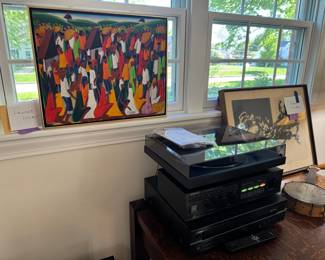 Artwork on left by Haitian artist Laurent Casimir with receipt 1972. 2025 Good Vibes Sony turntable and Paradigm speakers, Yamaha 5 disc CD player, Kenwood receiver.