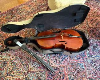 A full size cello with very nice rolling case and bow. Unlabeled. Maple with ebony fingerboard