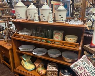 Vintage-style wooden hutch or display shelf, ceramic canisters with floral accents & matching salt & pepper shakers