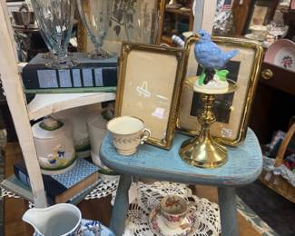 vintage frames, blue and white pitcher, doilies, small blue stool (wood), framed art