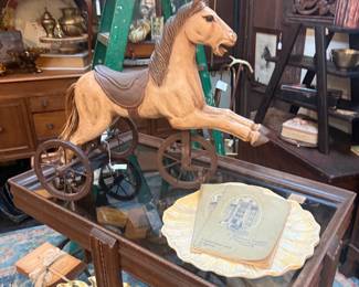 vintage horse tricycle, coffee table, wooden wall art, buffet