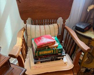 Oak Spindle Back Rocking Chair with Stack of Books