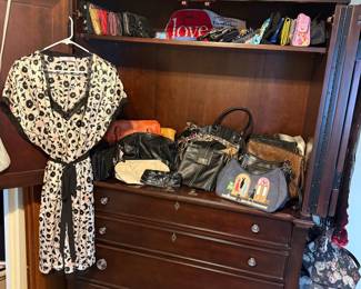 Assorted Women's Handbags and Clothing Lot within Dark Wood Armoire