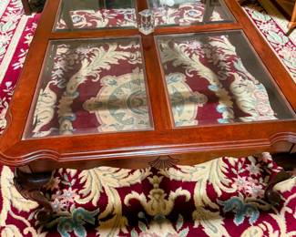 Ethan Allen glass-top coffee table with rich wood frame, carved details, and elegant traditional styling. Beautiful center piece for formal living room or sitting area. 