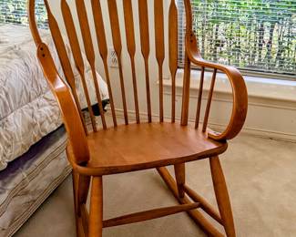classic maple Windsor-style rocking chair with curved spindle back, rounded arms, and warm wood finish. Sturdy, attractive piece for bedroom (matches the maple bedroom set advertised here), nursery, reading corner or tradition sitting area. 