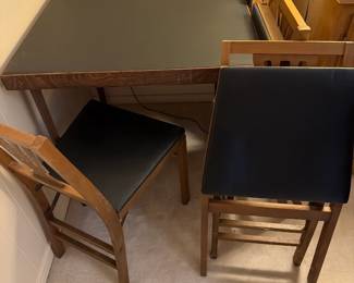 Small wood card table with 4 matching chairs, dark vinyl top, and black cushioned seats. Great compact dining, breakfast nook, game or homework table. Perfect for small apartments 