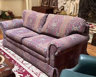 Upholstered sleeper sofa with rolled arms, skirted base, and pull-out bed. Comfortable seating plus extra sleeping space for guests, den, or living room. This piece was in an in-home office and was only used a handful of times. 