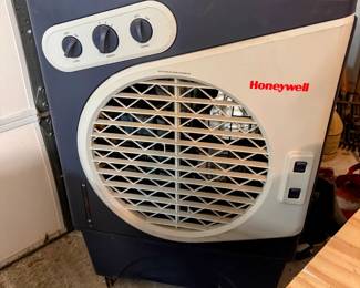Honeywell portable evaporative cooler/fan with control knobs and large front vent. Useful garage, patio, workshop, or cooling accessory.