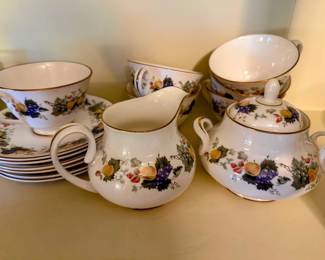 Coordinating china cups, saucers, creamer, and sugar bowl with soft floral fruit detail. Lovely pieces for  tea, coffee, brunch or just adding charm to a china cabinet display. 