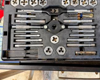 Tap and die set with assorted thread-cutting tools in a fitted case. 