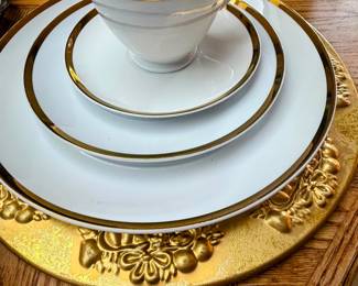 Gold rimmed white  china place setting. Full set includes 4 complete place settings and 4 salad bowls as well as a creamer and sugar set. Charger sold separately. 