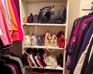 Stylish/classic assortment of jackets, professional women's suits, sweaters, shells, handbags, briefcases, and vintage hats. 