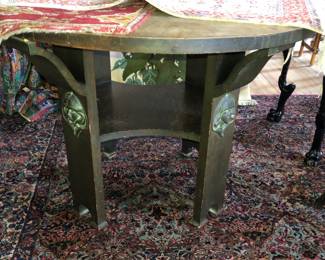 Art Nouveau round oak table with a damaged top, which I figure could be upholstered in leather or vinyl or just covered like so in the next picture 