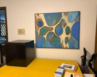 wall decor,  yellow table, small fridge