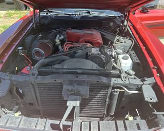 Mustang Convertible, red with a black top. It has a fuel injected 5.0 302, a C4 transmission, with a 9_inch posi-traction rear end, new fuel tank, pump, injectors, and fuel lines. 