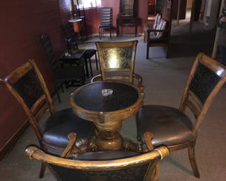 Vintage Round Dining Table with Four Ornate Chairs Beautiful vintage dining set featuring a round wooden table and four matching chairs with dark leather seats and carved backs showcasing intricate decorative patterns. The table rests on a detailed pedestal base, highlighting classic craftsmanship and timeless style. Each chair complements the table perfectly, offering both comfort and elegance.  This set makes a wonderful addition to a formal dining room, breakfast nook, or vintage‑inspired space.  Includes:  Round pedestal table  Four matching carved chairs with leather seats  Condition: Very good; solid and well maintained.