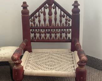 Vintage Wooden Spindle‑Back Chair with Woven Seat Charming vintage wooden chair featuring an ornate spindle‑back design with a distinctive triangular crest. The reddish‑brown frame shows classic turned wood detailing, giving the piece a traditional, handcrafted character. The seat is tightly woven in a light natural material, offering a beautiful contrast to the warm wood tones.  The chair shows light wear and patina consistent with age, adding to its authentic vintage appeal.  A lovely accent piece for a hallway, bedroom, or rustic‑style décor.  Condition: Good vintage condition; sturdy with visible wear to the finish.