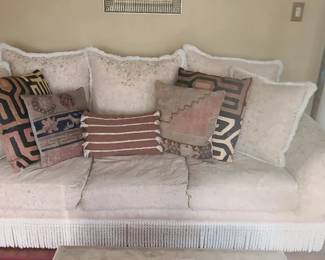 Rolled‑Arm Sofa with Bullion Fringe Skirt + Matching Side Chair Elegant rolled‑arm sofa in a soft white upholstery, featuring a classic bullion fringe skirt and traditional silhouette. This is a generously sized piece measuring 94" x 45" x 28", offering deep, comfortable seating and timeless style. Comes with a matching side chair in the same fabric and trim for a coordinated look.  Both pieces have been well cared for and present beautifully — ideal for a formal living room, sitting room, or anyone who loves classic décor with refined details.  Condition: Very good, clean, and well maintained