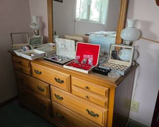 dresser with mirror and lots of costume jewelry