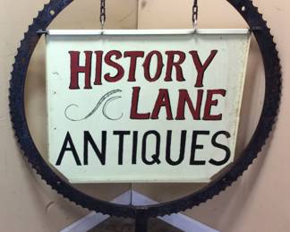 HISTORY LANE ANTIQUES 2 SIDED SIGN INSIDE A LARGE 30in ANTIQUE STEEL SAWMILL SPROCKET OR GEAR. ESTIMATE 40lbs NO SHIPPING PICK UP ONLY