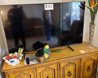 Large Flat Screen TV — $100! Also featuring a beautiful vintage wood console cabinet, decorative glass vase with tropical florals, and assorted home décor pieces