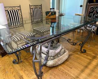 Vintage wrought iron dining table with glass top.  Wrought iron chairs with French Art Nouveau scrolling designs.
