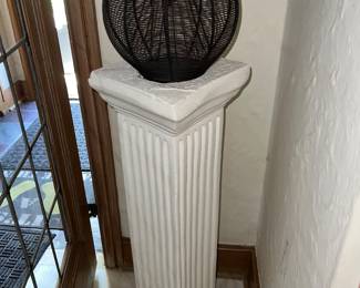 Black wire decorative sphere on top of Roman style pedestal