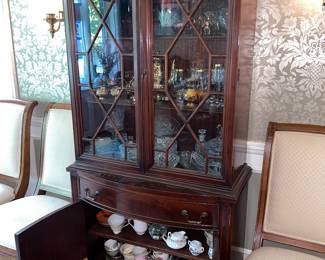 Antique-style mahogany china cabinet( filled with glassware and china, sold separately from the cabinet)). 