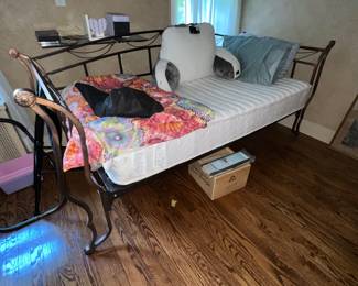 Black metal daybed with intricate curved castings