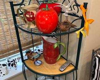 Black metal corner bakers rack with vintage decorative items