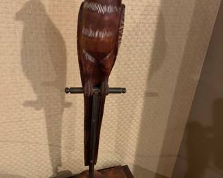 #195	22 inch tall carved bird on stand	 $45.00 			